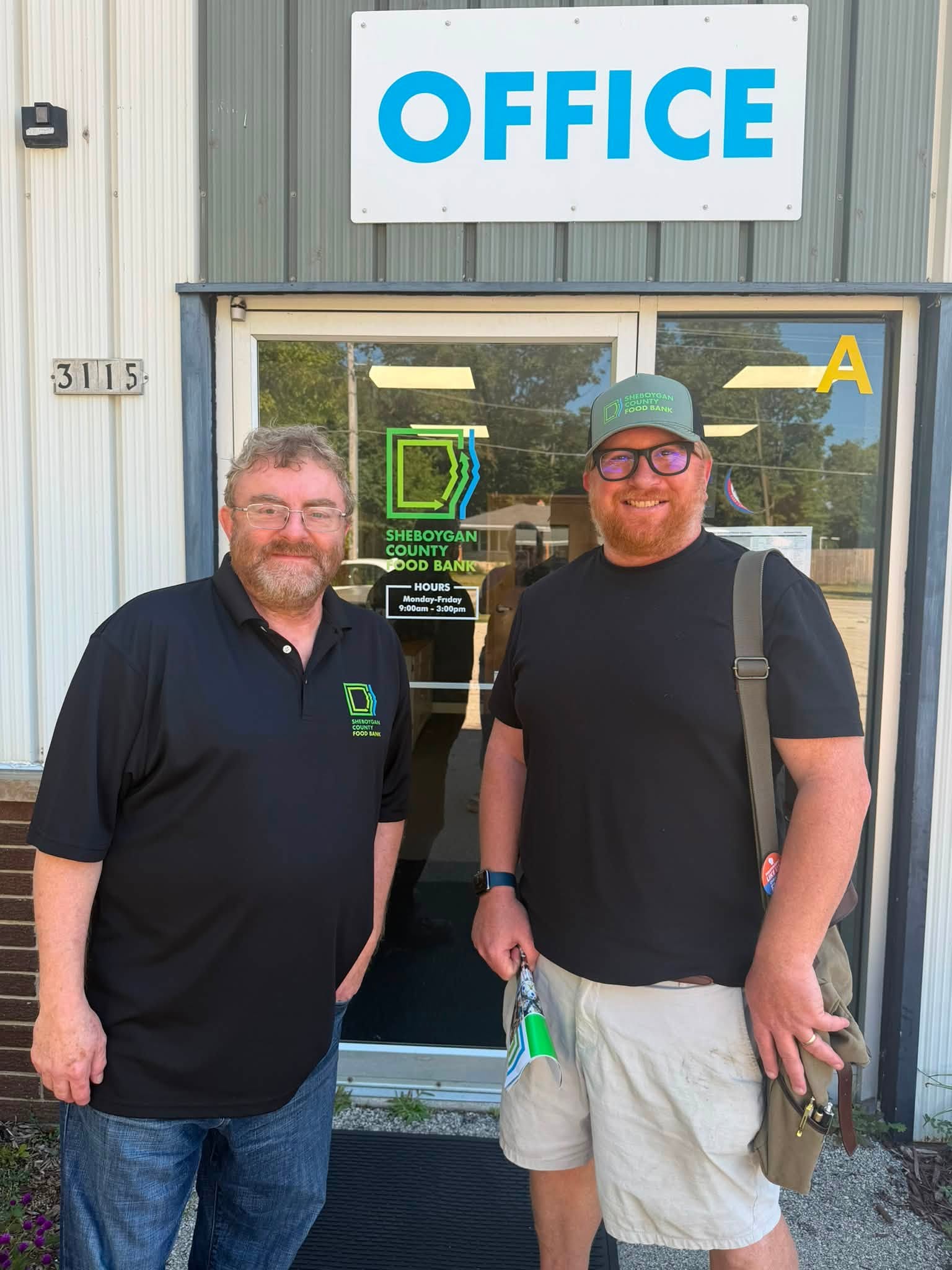 Christian at the Sheboygan County Food Bank, standing with the Executive Director Patrick Boyle