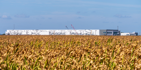 A data center stands in a corn field under a blue-grey sky. BackyardProduction / iStock / Getty Images Plus